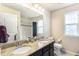 The bathroom features double sinks, granite countertop, a large vanity mirror, and a tiled shower at 6817 Sequoia St, Frederick, CO 80530