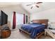 Bright bedroom featuring a vaulted ceiling, a ceiling fan, a large window, and a decorative banner at 6817 Sequoia St, Frederick, CO 80530