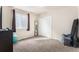A simple bedroom with plush carpet, a window, and a bi-fold closet at 6817 Sequoia St, Frederick, CO 80530