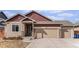 A lovely home with brick accents, a well-kept lawn and a large three car garage at 6817 Sequoia St, Frederick, CO 80530