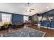 Inviting living room with a stylish rug, ceiling fan, and an open concept to the kitchen at 6817 Sequoia St, Frederick, CO 80530
