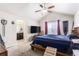 A spacious bedroom with vaulted ceiling and ceiling fan is adjacent to an ensuite bathroom at 6817 Sequoia St, Frederick, CO 80530
