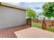 Wood back deck overlooks a well-maintained yard with privacy fence and mature trees at 9215 W Swarthmore Dr, Littleton, CO 80123
