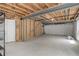 Unfinished basement with concrete floor, and exposed overhead support beams at 9215 W Swarthmore Dr, Littleton, CO 80123