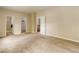 Spacious bedroom with neutral carpet and paint, featuring an adjoining ensuite at 9215 W Swarthmore Dr, Littleton, CO 80123