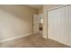 Cozy bedroom with plush carpet, neutral paint, and a closet for storage at 9215 W Swarthmore Dr, Littleton, CO 80123