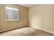 Neutral bedroom featuring a large window for ample natural light and comfortable carpet at 9215 W Swarthmore Dr, Littleton, CO 80123