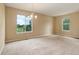 Spacious dining room with neutral walls, carpeting, and large windows with neighborhood views at 9215 W Swarthmore Dr, Littleton, CO 80123