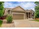Inviting home with neutral siding, a two-car garage, and a well-maintained front yard at 9215 W Swarthmore Dr, Littleton, CO 80123