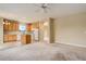 Open concept living room and kitchen with tile floors and neutral carpet at 9215 W Swarthmore Dr, Littleton, CO 80123