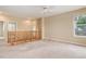 Upstairs living room area with neutral carpet, natural lighting, and open layout at 9215 W Swarthmore Dr, Littleton, CO 80123