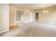 Open-concept living room with neutral tones, carpeting, and seamless transitions to other rooms at 9215 W Swarthmore Dr, Littleton, CO 80123