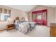 Vaulted primary bedroom with large bay window and neutral carpet and paint at 16222 E Prentice Ln, Centennial, CO 80015