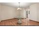 Dining room features hardwood floors, modern chandelier, and an adjacent eat-in kitchen at 16222 E Prentice Ln, Centennial, CO 80015