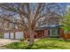 Charming two-story brick home featuring mature trees in the front yard at 16222 E Prentice Ln, Centennial, CO 80015