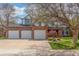 Charming two-story brick home featuring a three-car garage, manicured lawn, and mature landscaping at 16222 E Prentice Ln, Centennial, CO 80015