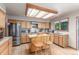 Functional kitchen with stainless steel appliances, light wood cabinetry, and a central island at 16222 E Prentice Ln, Centennial, CO 80015