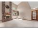 Cozy living room features a brick fireplace with a mantle, multiple large windows, and neutral decor at 16222 E Prentice Ln, Centennial, CO 80015