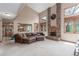 Spacious living room with a brick fireplace, high ceilings, and large windows at 16222 E Prentice Ln, Centennial, CO 80015