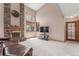 Comfortable living room featuring a brick fireplace, high ceilings, and ample natural light at 16222 E Prentice Ln, Centennial, CO 80015