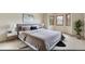 The primary bedroom features natural light from the bay windows and neutral decor at 16222 E Prentice Ln, Centennial, CO 80015