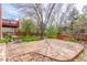 Spacious backyard patio with stone pavers, mature landscaping, and nice lawn at 16222 E Prentice Ln, Centennial, CO 80015