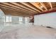 Unfinished basement featuring exposed wooden beams, concrete floor and natural light from windows at 4414 Walden St, Denver, CO 80249