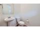 Powder room featuring a pedestal sink, modern toilet, and neutral paint color at 4414 Walden St, Denver, CO 80249