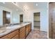 Bathroom featuring a double vanity with granite countertop, tile floors, and walk-in shower at 4414 Walden St, Denver, CO 80249