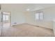 A bright bonus room features neutral carpet and paint, and natural light from a large window at 4414 Walden St, Denver, CO 80249