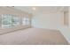 Bright, airy room with neutral carpet, tray ceilings, and large windows offering an abundance of natural light at 4414 Walden St, Denver, CO 80249