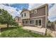 Rear exterior view of a two-story home with sliding glass door leading to patio at 4414 Walden St, Denver, CO 80249