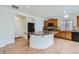 Bright kitchen with wood cabinets, an island with stone countertop, and hardwood flooring, perfect for entertaining at 4414 Walden St, Denver, CO 80249
