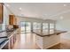 An open kitchen offers an island and views to the backyard through large sliding glass doors at 4414 Walden St, Denver, CO 80249