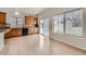 An open kitchen offers wood cabinets, granite countertops, and a view to the back patio at 4414 Walden St, Denver, CO 80249