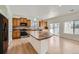 A spacious kitchen features wood cabinets, stone countertops, modern appliances, and an island at 4414 Walden St, Denver, CO 80249