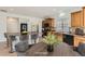 An eat-in kitchen features an island with seating, wood cabinets, and stainless steel appliances at 4414 Walden St, Denver, CO 80249