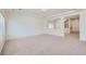 A bright living room offers neutral colored carpet, recessed lights, and large windows at 4414 Walden St, Denver, CO 80249
