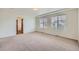 Spacious main bedroom with neutral carpet, tray ceiling, and natural light from large windows at 4414 Walden St, Denver, CO 80249