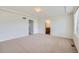 Spacious main bedroom with neutral carpet and ensuite bathroom and walk-in closet entrances at 4414 Walden St, Denver, CO 80249