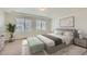 A staged main bedroom features two windows, neutral paint and carpet, and tray ceiling at 4414 Walden St, Denver, CO 80249