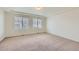 A main bedroom offers neutral paint and carpet, two windows, and a tray ceiling at 4414 Walden St, Denver, CO 80249