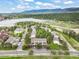 Wide aerial view of homes, green landscape, and a lake showcasing the beautiful surrounding scenery at 404 Raspberry Ln, Monument, CO 80132