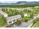 Aerial view showcases the townhomes surrounded by lush landscape with mountains in the background at 404 Raspberry Ln, Monument, CO 80132