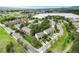 Aerial view highlighting homes surrounded by trees and overlooking a serene lake and neighborhood at 404 Raspberry Ln, Monument, CO 80132