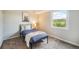 Cozy bedroom featuring a comfortable bed, stylish decor, and a window offering outdoor views at 404 Raspberry Ln, Monument, CO 80132