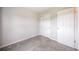 Bright bedroom with neutral walls, soft carpeting, a view to the hallway and closet at 404 Raspberry Ln, Monument, CO 80132