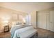 Cozy bedroom featuring a comfortable bed with stylish linens, neutral walls, and access to a closet and hallway at 404 Raspberry Ln, Monument, CO 80132