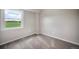 Bright bedroom with neutral walls, soft carpeting, and a large window with scenic outdoor views at 404 Raspberry Ln, Monument, CO 80132