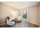 Inviting bedroom featuring plush carpet, a large window, and comfortable seating area at 404 Raspberry Ln, Monument, CO 80132
